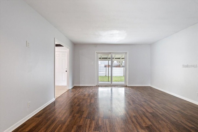 empty room featuring dark hardwood / wood-style flooring