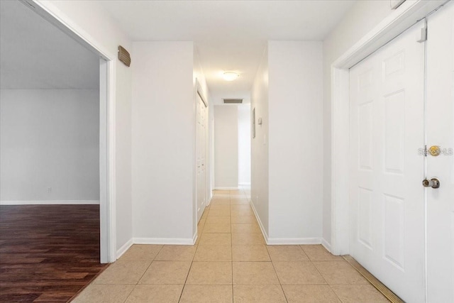 hallway with light hardwood / wood-style flooring