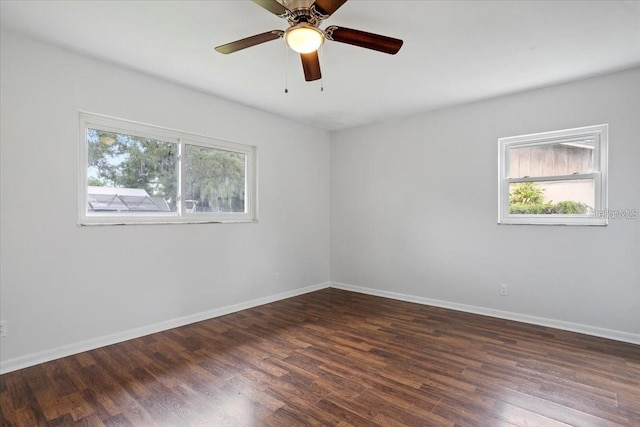 unfurnished room with dark wood-type flooring, ceiling fan, and a healthy amount of sunlight