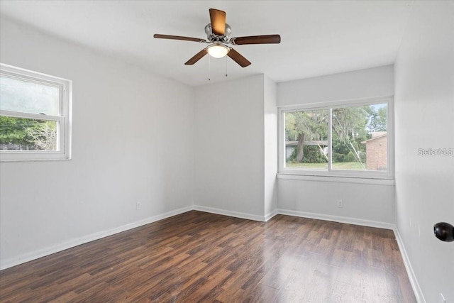 spare room featuring ceiling fan and dark hardwood / wood-style floors