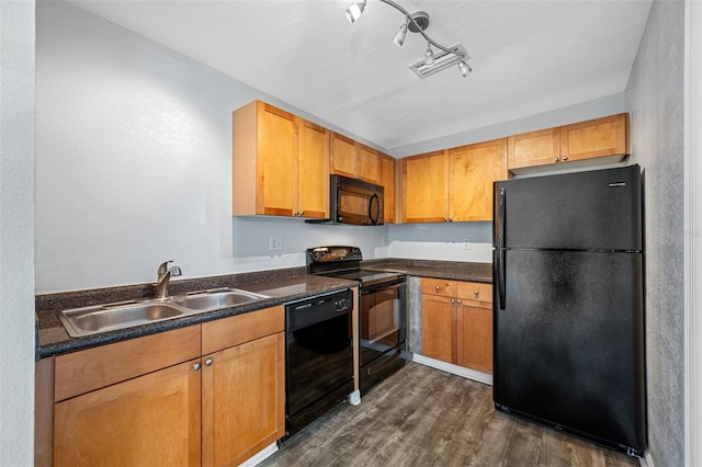 kitchen with dark hardwood / wood-style flooring, sink, and black appliances