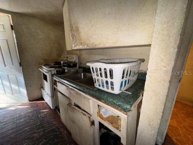 interior space with sink and white gas range oven