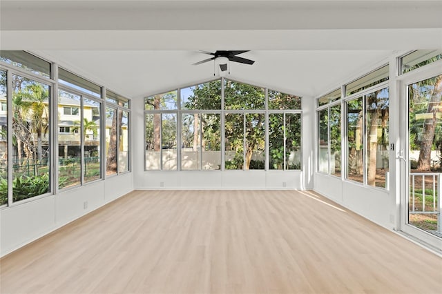 unfurnished sunroom with ceiling fan and vaulted ceiling