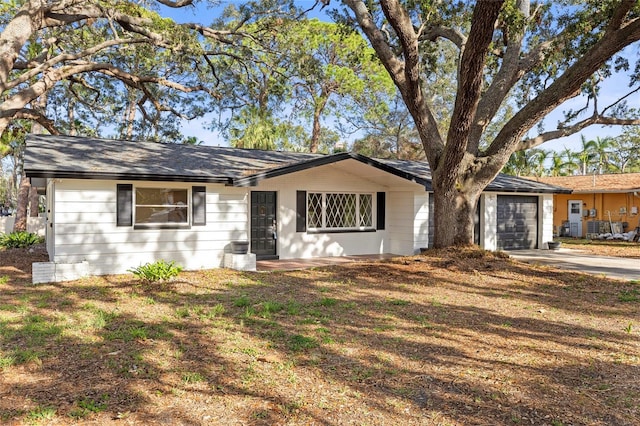 single story home featuring a garage and a front yard