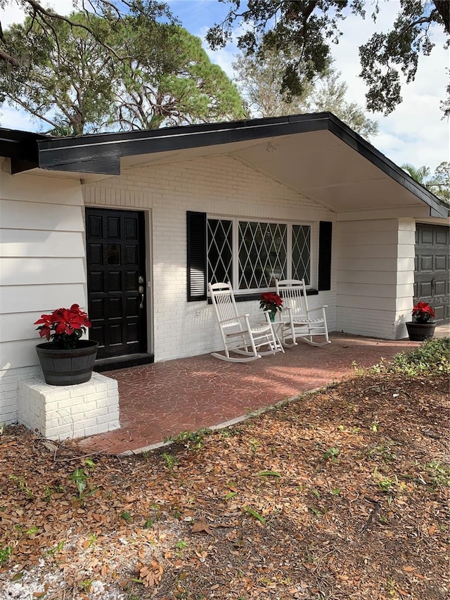 back of property with covered porch