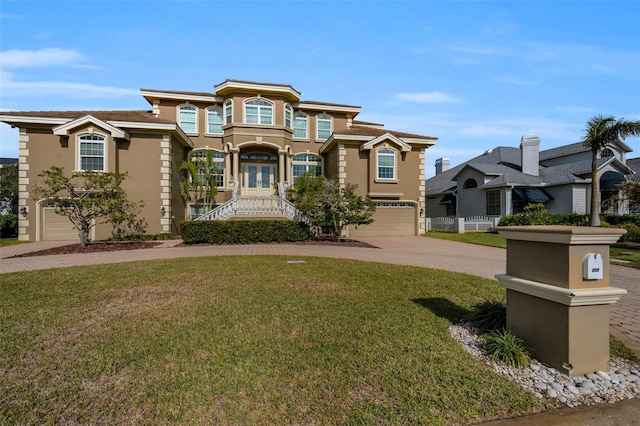 view of front of home featuring french doors, a front lawn, and a garage