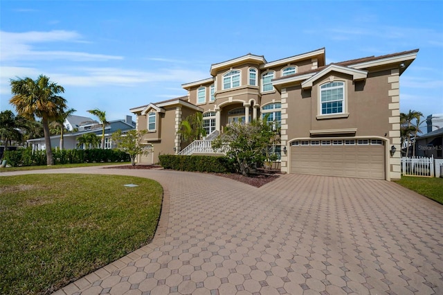 view of front of property with a front yard and a garage