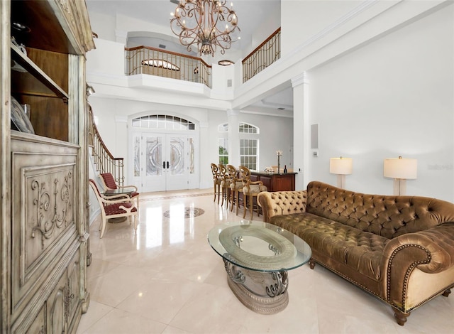 119 8th St E, Tierra Verde, FL 33715 - living room with a chandelier, a high ceiling, and stairs