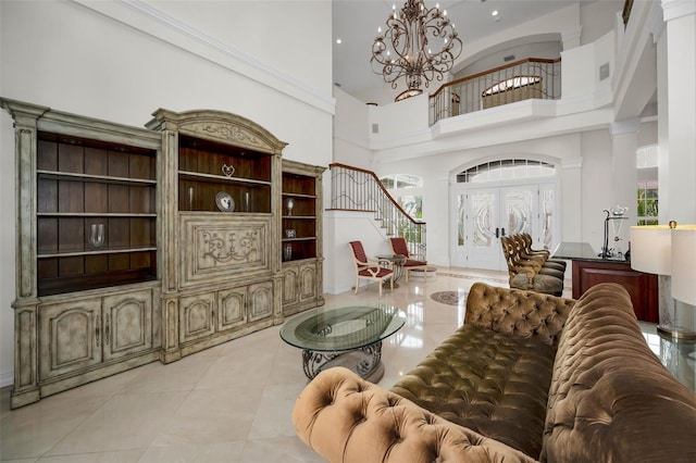 living room with a chandelier, a high ceiling, light tile patterned floors, and french doors