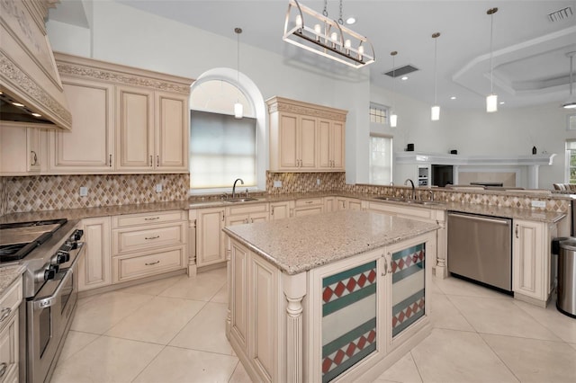 kitchen featuring pendant lighting, a center island, sink, tasteful backsplash, and stainless steel appliances