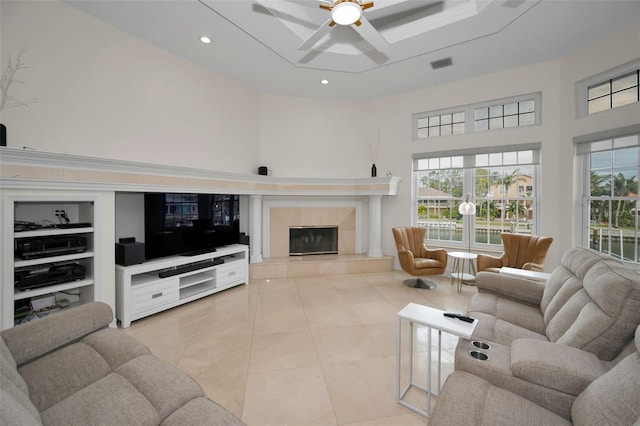 119 8th St E, Tierra Verde, FL 33715 - living area with a high ceiling, a fireplace, ceiling fan, plenty of natural light, and light tile patterned floors