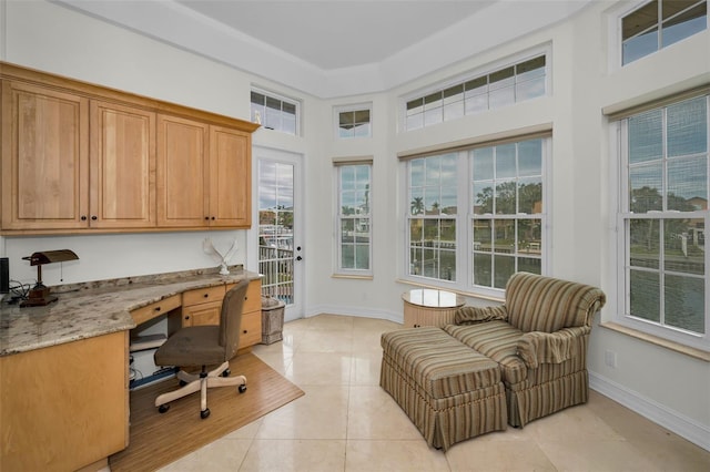 119 8th St E, Tierra Verde, FL 33715 - office area featuring built in desk, light tile patterned floors, healthy amount of natural light, and a towering ceiling