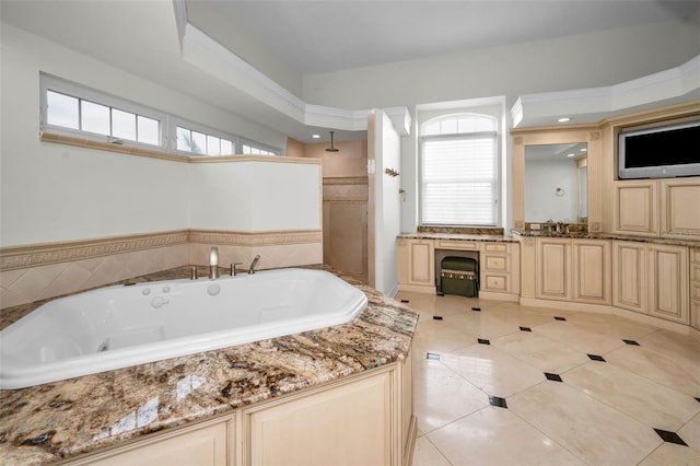 119 8th St E, Tierra Verde, FL 33715 - bathroom with a jetted tub, tile patterned flooring, vanity, and a tile shower