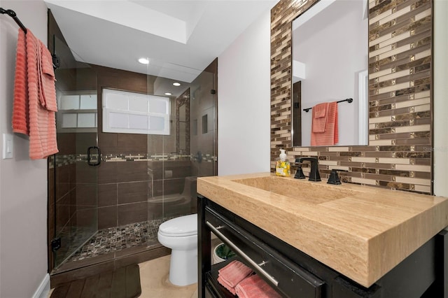 bathroom with backsplash, tile patterned floors, an enclosed shower, vanity, and toilet