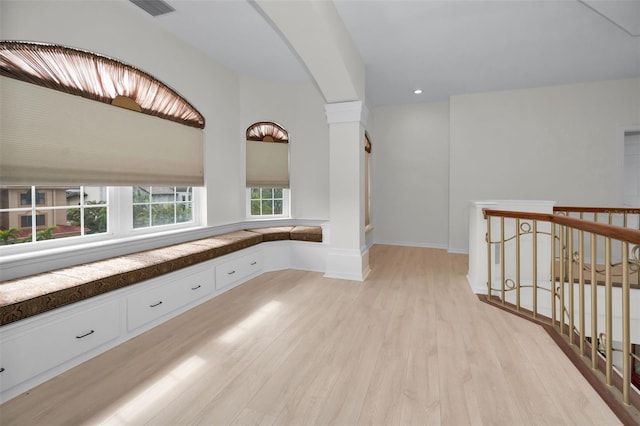 119 8th St E, Tierra Verde, FL 33715 - corridor featuring light wood-style flooring, arched walkways, an upstairs landing, and recessed lighting