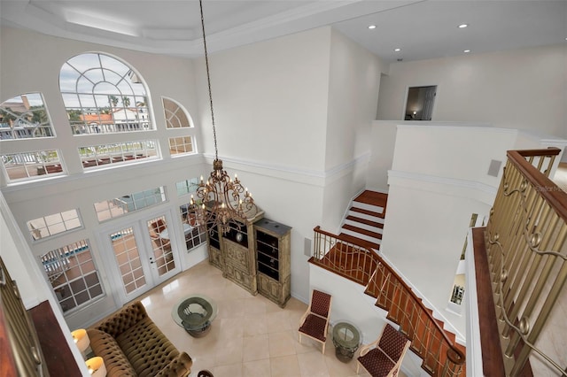 119 8th St E, Tierra Verde, FL 33715 - tiled living area with a chandelier, recessed lighting, french doors, and a high ceiling