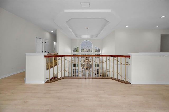 119 8th St E, Tierra Verde, FL 33715 - corridor featuring an upstairs landing, wood finished floors, a raised ceiling, and recessed lighting