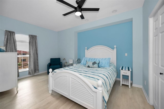 bedroom with light hardwood / wood-style floors and ceiling fan