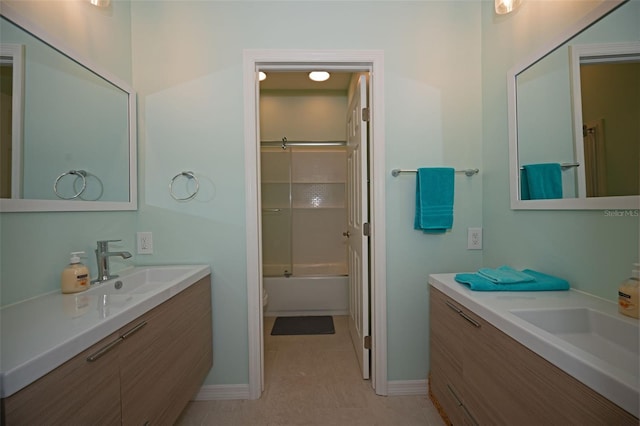 full bathroom featuring tile patterned floors, vanity, toilet, and bath / shower combo with glass door