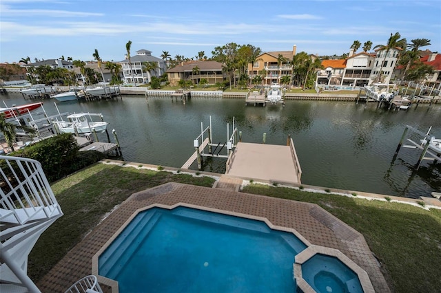 119 8th St E, Tierra Verde, FL 33715 - view of pool with boat lift, a water view, a residential view, a boat dock, and a pool with connected hot tub
