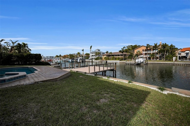 view of dock with a lawn and a water view