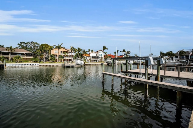 119 8th St E, Tierra Verde, FL 33715 - dock with boat lift, a water view, and a residential view