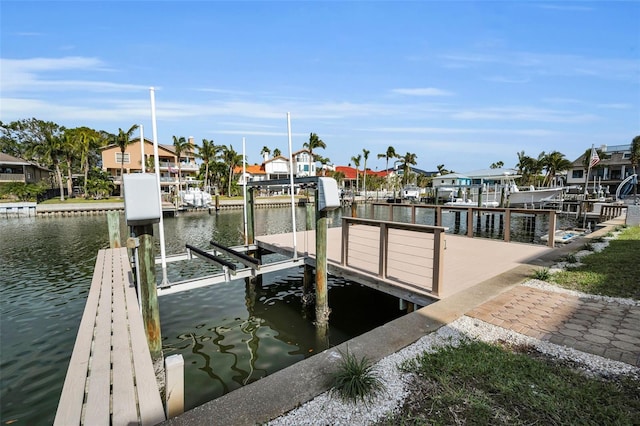 119 8th St E, Tierra Verde, FL 33715 - dock featuring boat lift, a water view, and a residential view
