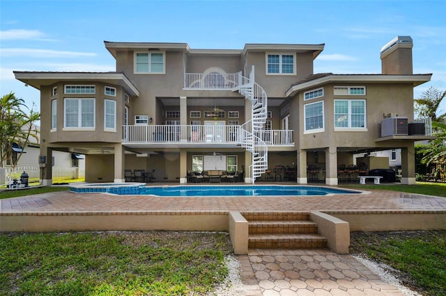 back of property with a patio area and central AC unit