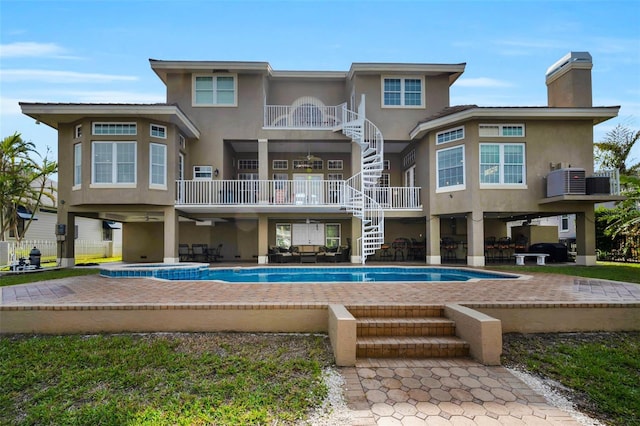 119 8th St E, Tierra Verde, FL 33715 - back of house with stairs, stucco siding, a balcony, an outdoor pool, and a patio