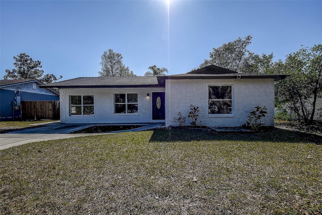 ranch-style home with a front lawn