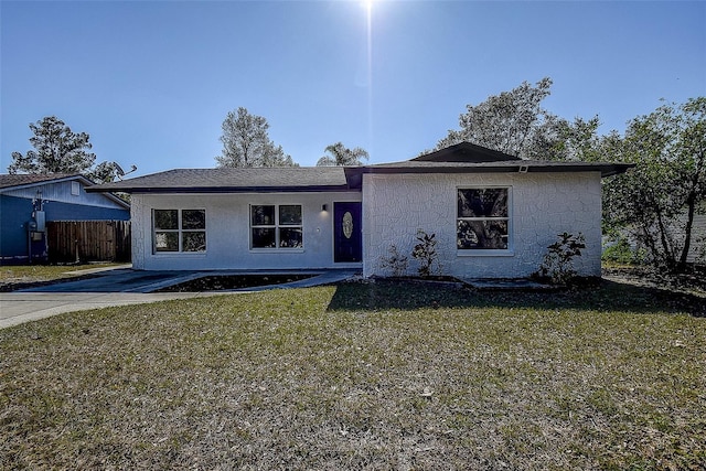 ranch-style home with a front lawn