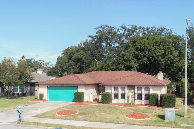 view of front of home featuring a garage and a front lawn