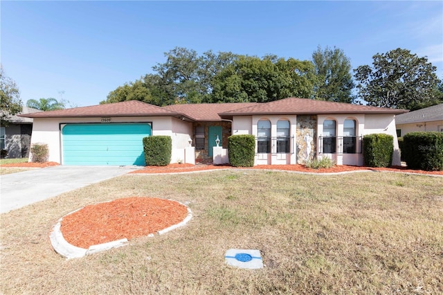 ranch-style house featuring a garage and a front lawn