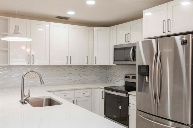 kitchen featuring white cabinets, sink, and stainless steel appliances