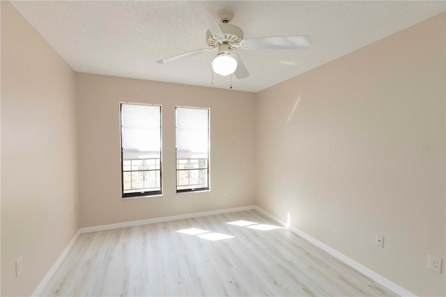 unfurnished room featuring ceiling fan, light hardwood / wood-style floors, and a textured ceiling