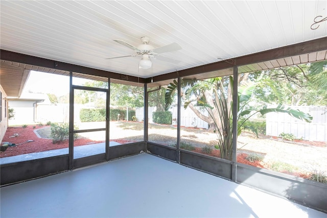 unfurnished sunroom with ceiling fan