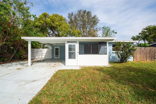 exterior space with a front yard and a carport