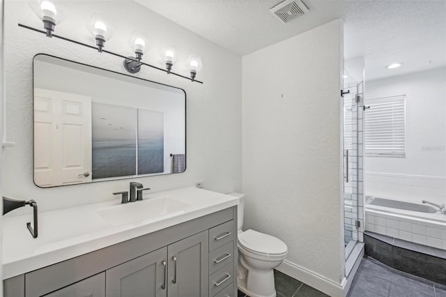 full bathroom featuring vanity, tile patterned floors, separate shower and tub, toilet, and a textured ceiling