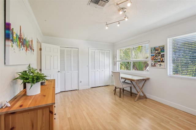 office area featuring hardwood / wood-style floors, crown molding, and a textured ceiling