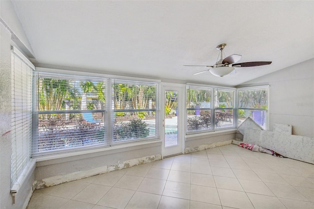 unfurnished sunroom featuring ceiling fan and vaulted ceiling