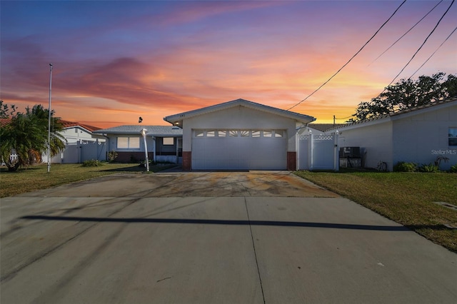 view of front of property featuring a garage and a yard