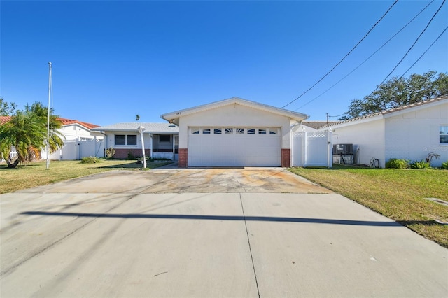 single story home featuring a garage and a front lawn