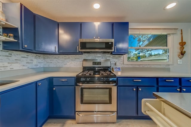 kitchen featuring a textured ceiling, blue cabinetry, and appliances with stainless steel finishes