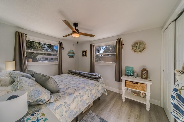 bedroom featuring ceiling fan, a closet, and hardwood / wood-style flooring