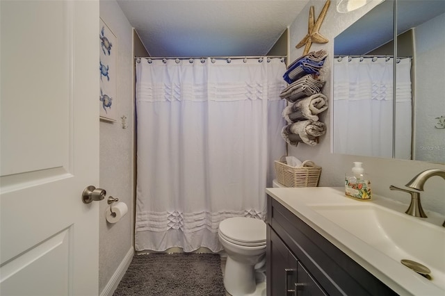 bathroom featuring curtained shower, vanity, a textured ceiling, and toilet