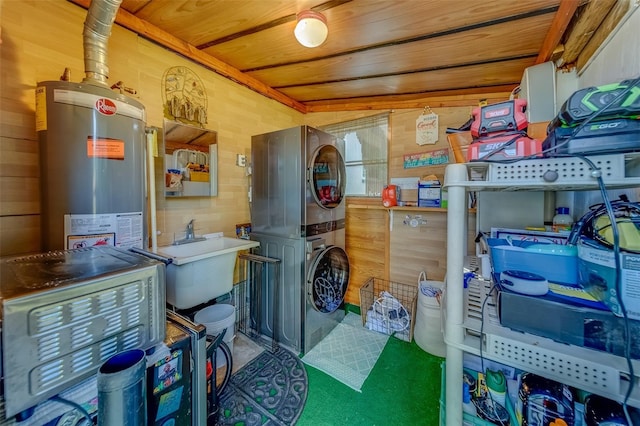 interior space featuring gas water heater, stacked washer and clothes dryer, and sink