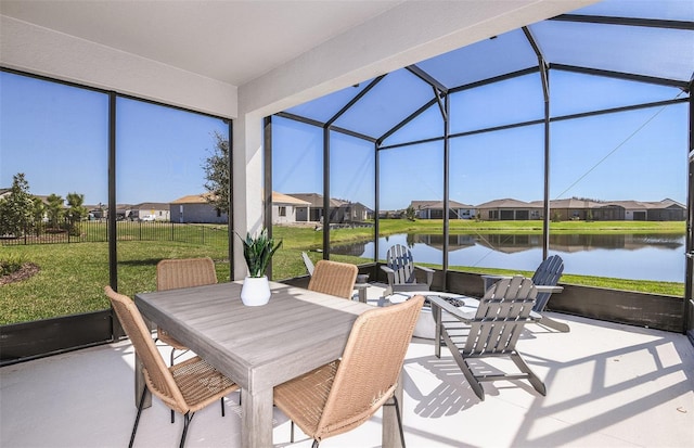 sunroom featuring a water view and a wealth of natural light