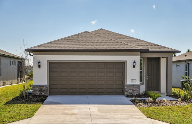 ranch-style house with a shingled roof, stone siding, and driveway