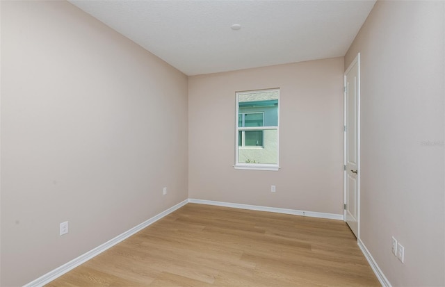 unfurnished room with light hardwood / wood-style flooring