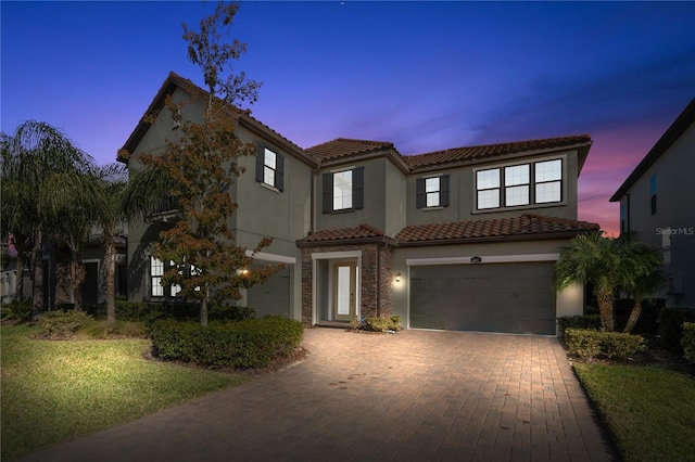 mediterranean / spanish house featuring a garage